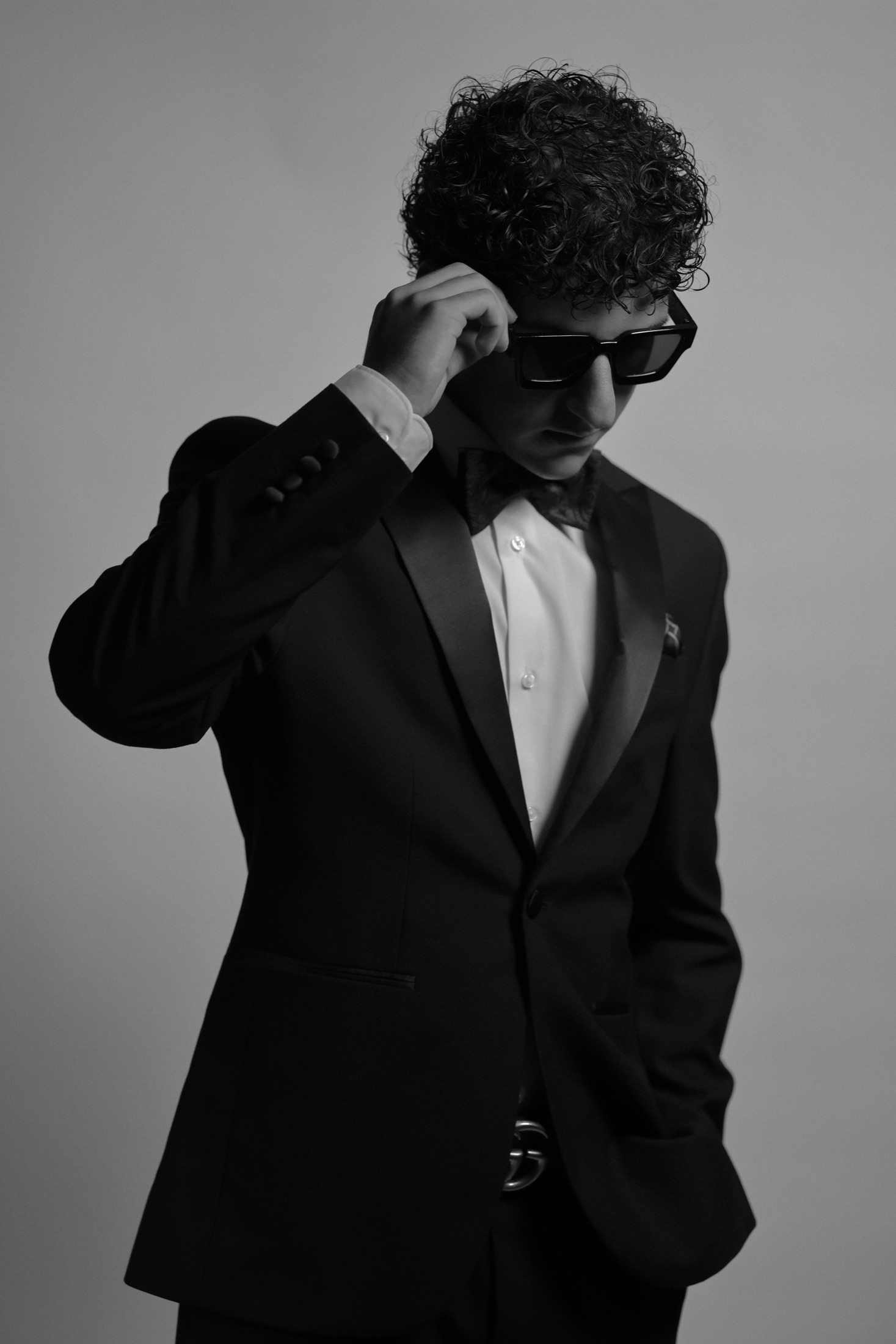 JIANNU wearing a tuxedo and sunglasses