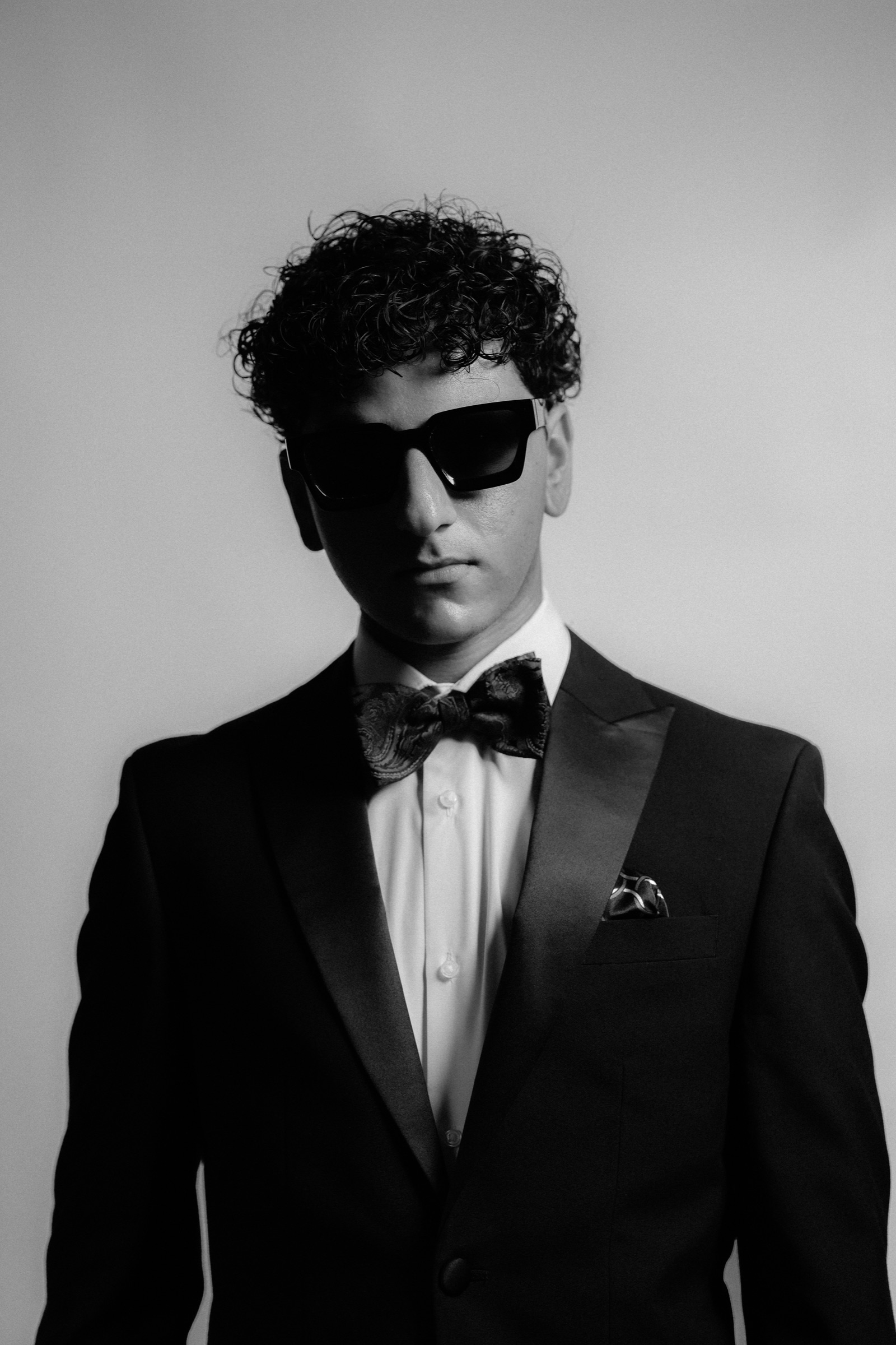 JIANNU dressed in a tuxedo and bow tie